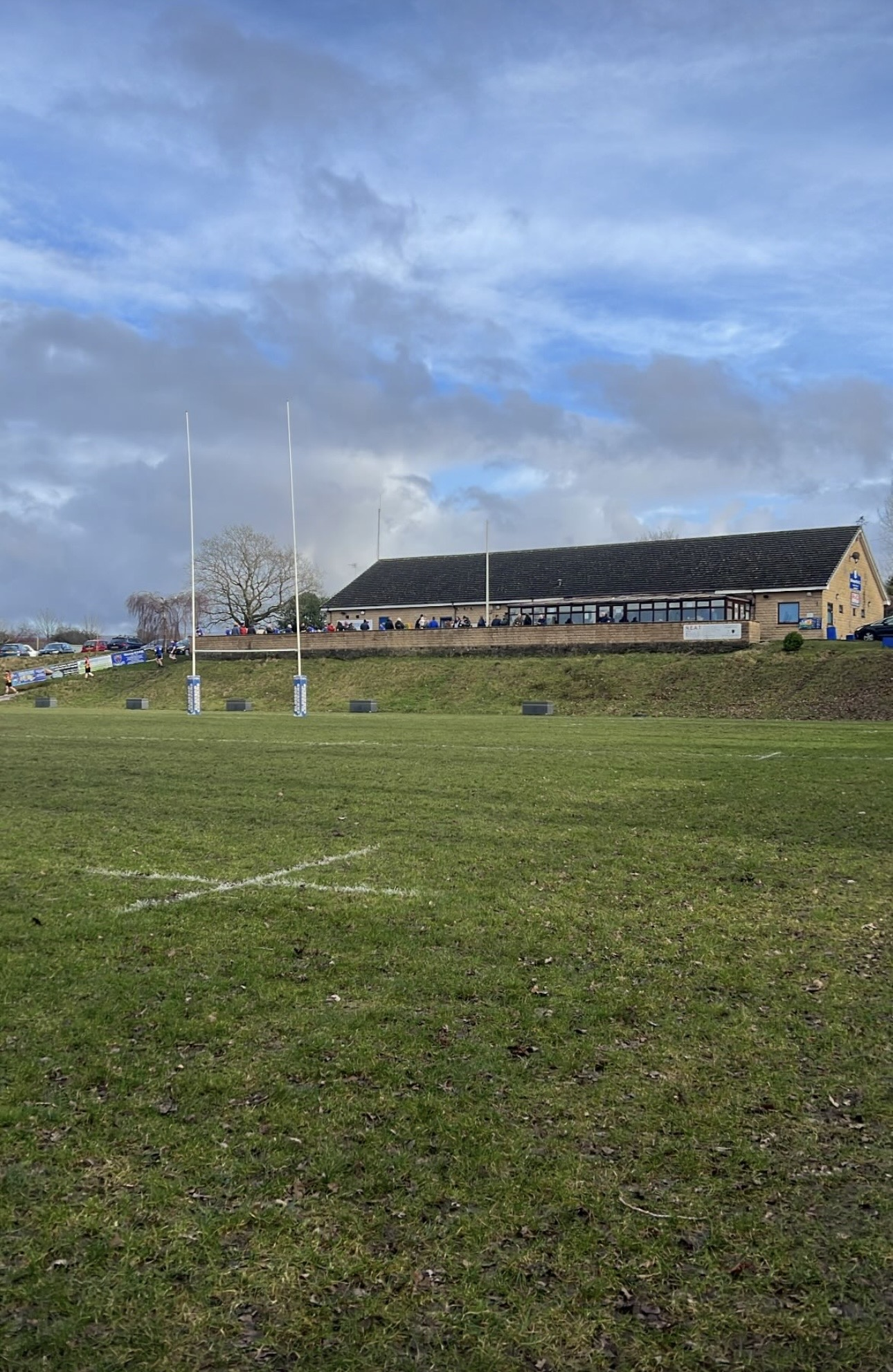 Rugby ground and goal posts under an open sky