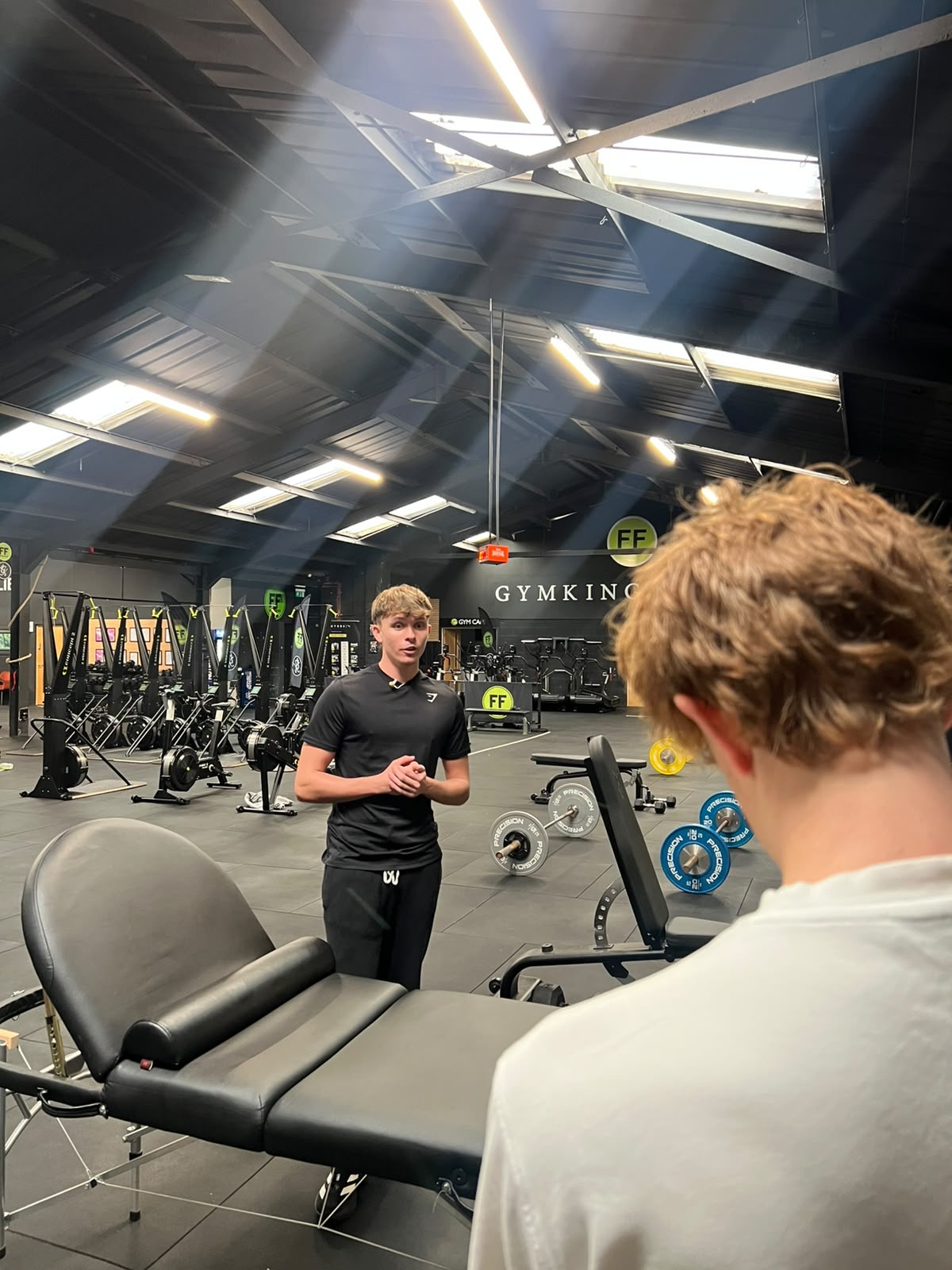 Ethan presenting in the gym with a treatment bed in the foreground