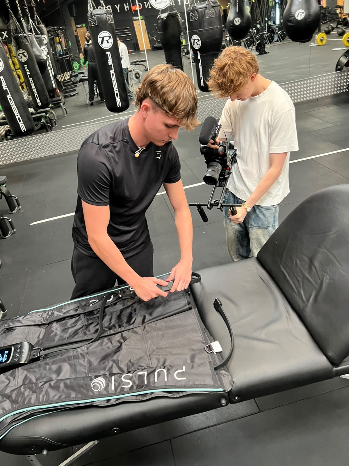 Ethan preparing compression recovery boots while being filmed